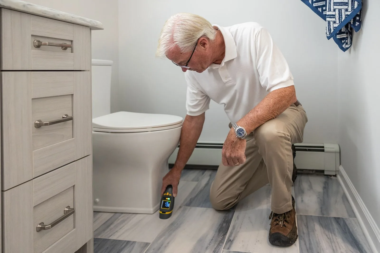Inspector checking plumbing inside a bathroom