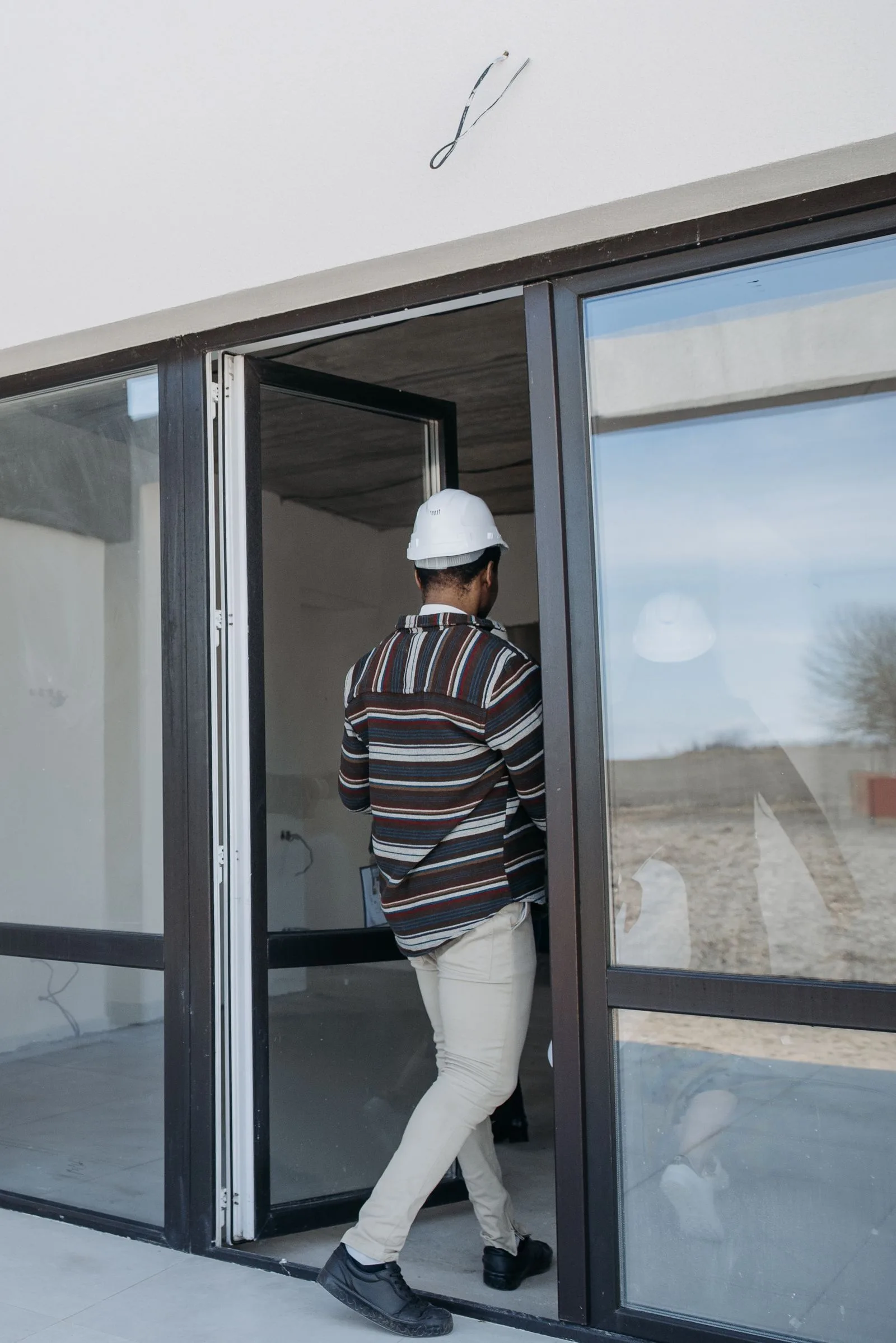 Professional standing at a patio door